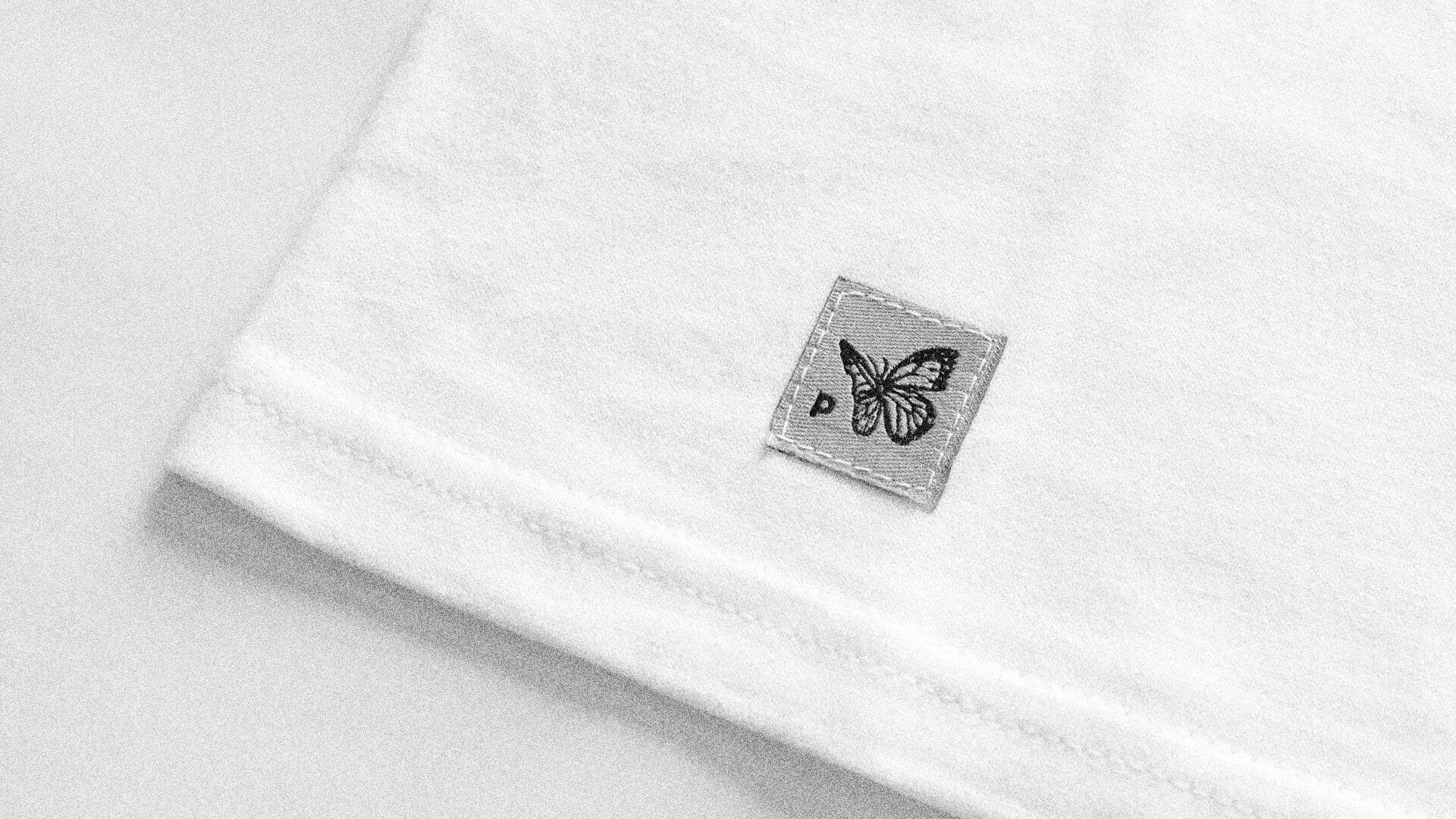 PHOSIS Clothing hand stitched tag cover