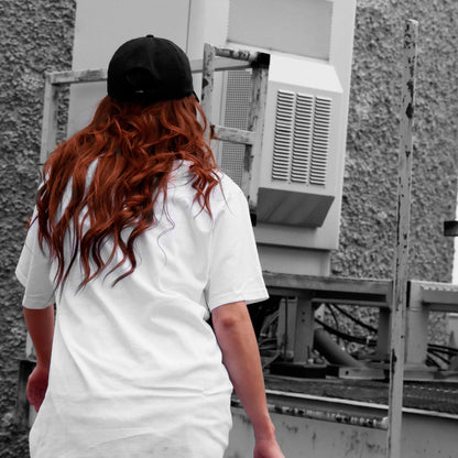 Back view of model wearing CONSUMED white t-shirt from PHOSIS Clothing