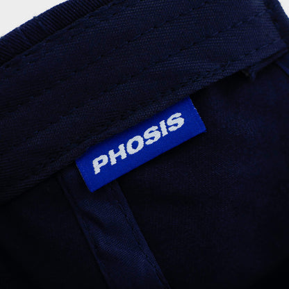 Close up view of the woven label in the Barbed Wire navy blue dad hat from PHOSIS Clothing